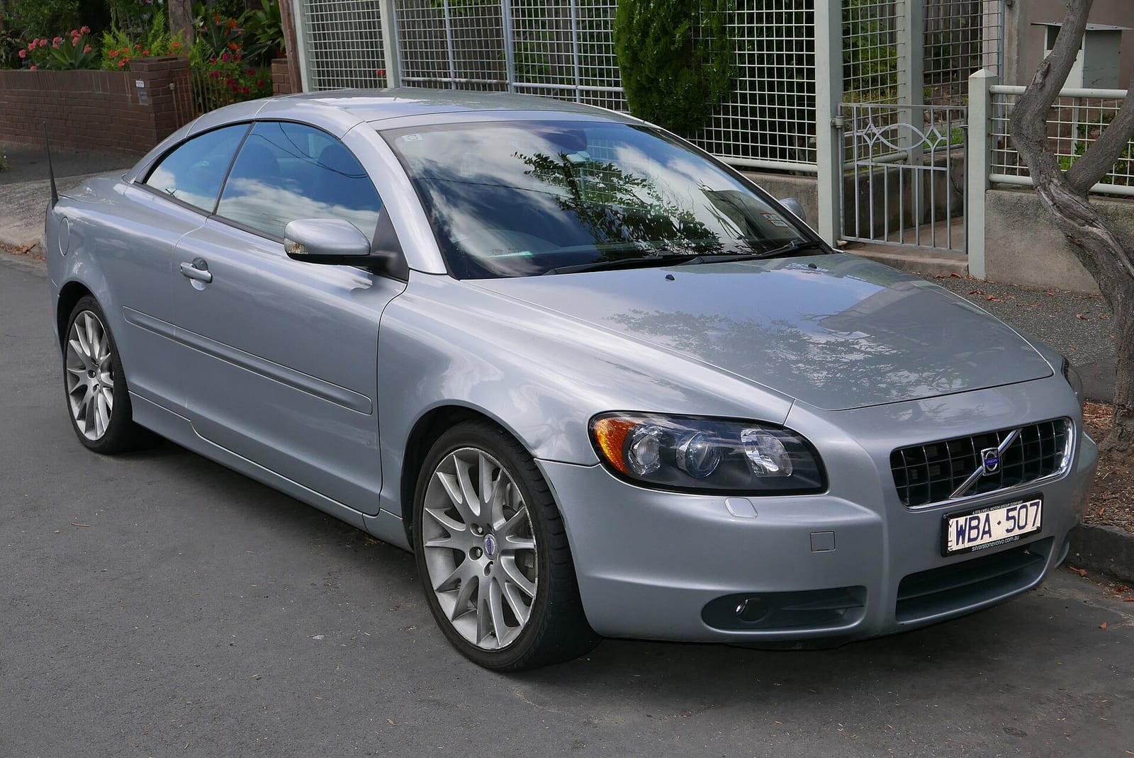 Silver 2007 Volvo C70 T5 convertible parked on a street with its hardtop raised, front three-quarter view