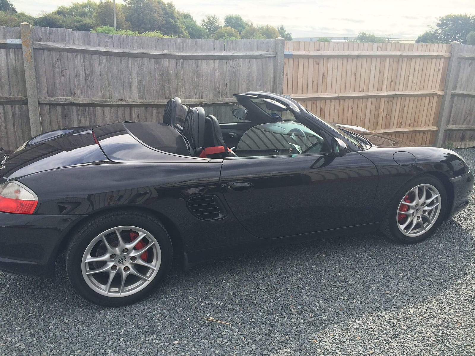 Black Porsche Boxster S (986) with the top down, side view